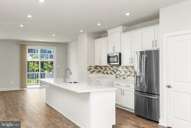 2270 Haw River Rd, Hanover, MD 21076 - kitchen with appliances with stainless steel finishes, a sink, dark wood-style flooring, a kitchen island with sink, and decorative backsplash