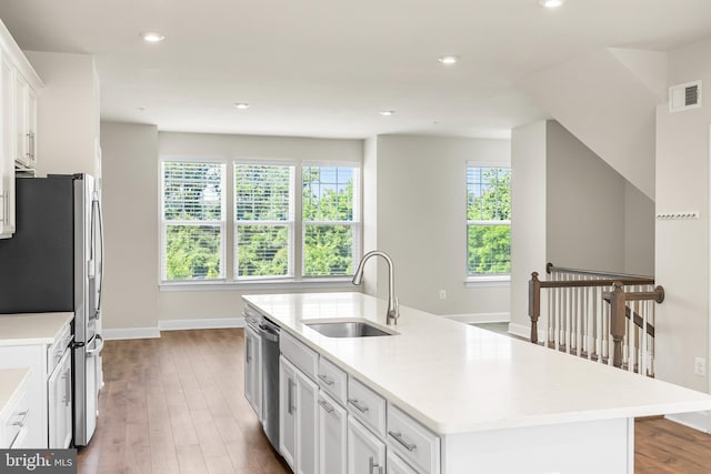 2270 Haw River Rd, Hanover, MD 21076 - kitchen featuring a sink, appliances with stainless steel finishes, baseboards, a kitchen island with sink, and wood finished floors