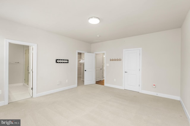 2270 Haw River Rd, Hanover, MD 21076 - unfurnished bedroom with light colored carpet, baseboards, a walk in closet, ensuite bath, and a closet