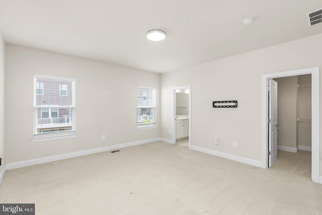 2270 Haw River Rd, Hanover, MD 21076 - unfurnished bedroom featuring a spacious closet, light colored carpet, baseboards, a closet, and ensuite bath