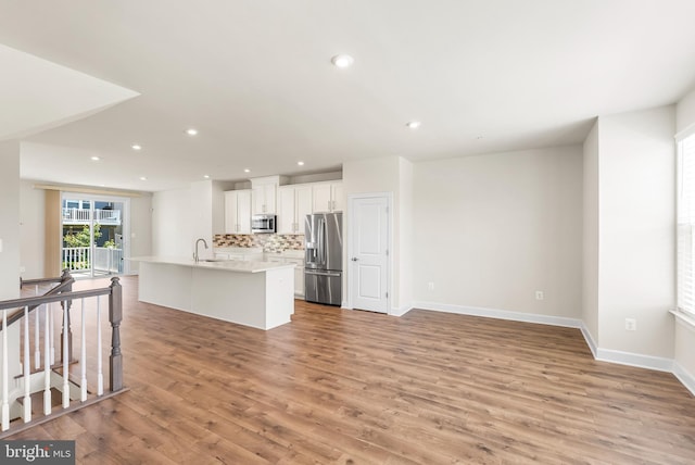 2270 Haw River Rd, Hanover, MD 21076 - kitchen featuring stainless steel appliances, a sink, backsplash, a center island with sink, and recessed lighting