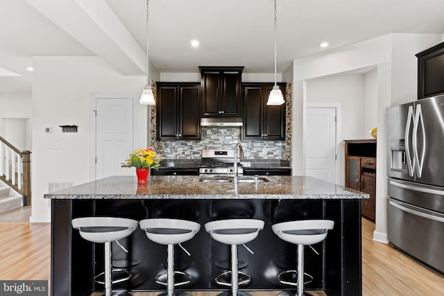 11 Kestrel Dr, Mechanicsburg, PA 17050 - kitchen with stainless steel appliances, a sink, decorative backsplash, a breakfast bar, and recessed lighting
