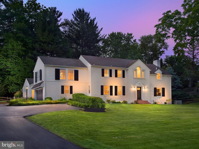 745 Conestoga Rd, Bryn Mawr, PA 19010 - view of front facade with a chimney and asphalt driveway