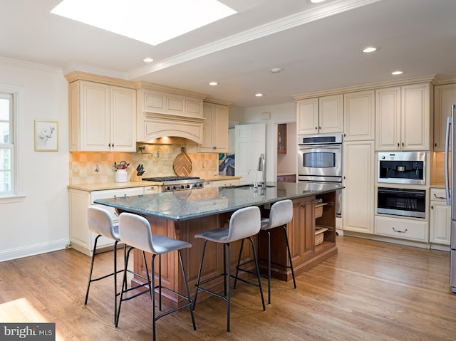 745 Conestoga Rd, Bryn Mawr, PA 19010 - kitchen with a sink, stainless steel double oven, backsplash, a kitchen bar, and crown molding