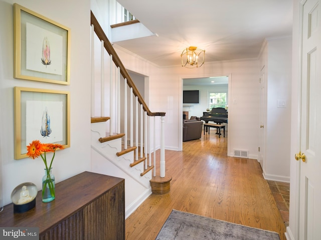 745 Conestoga Rd, Bryn Mawr, PA 19010 - foyer featuring a chandelier, crown molding, stairway, baseboards, and wood finished floors