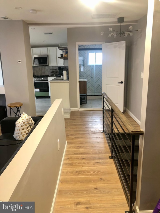 300 Darcy Ave, Hamilton, NJ 08629 - hall featuring light wood-style flooring and baseboards