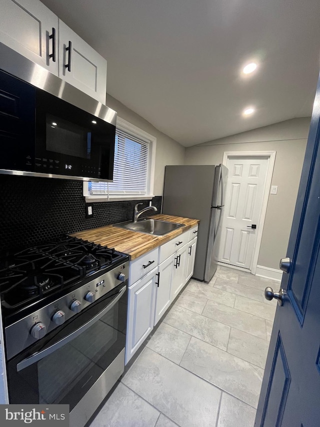 300 Darcy Ave, Hamilton, NJ 08629 - kitchen featuring stainless steel appliances, wood counters, a sink, decorative backsplash, and white cabinets