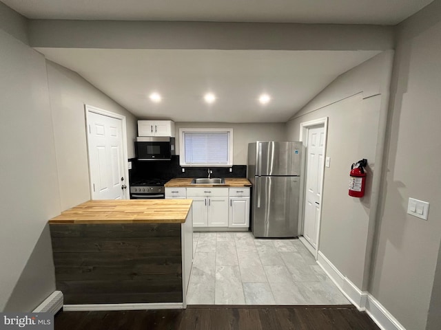 300 Darcy Ave, Hamilton, NJ 08629 - kitchen with appliances with stainless steel finishes, wood counters, vaulted ceiling, light wood-style floors, and white cabinetry