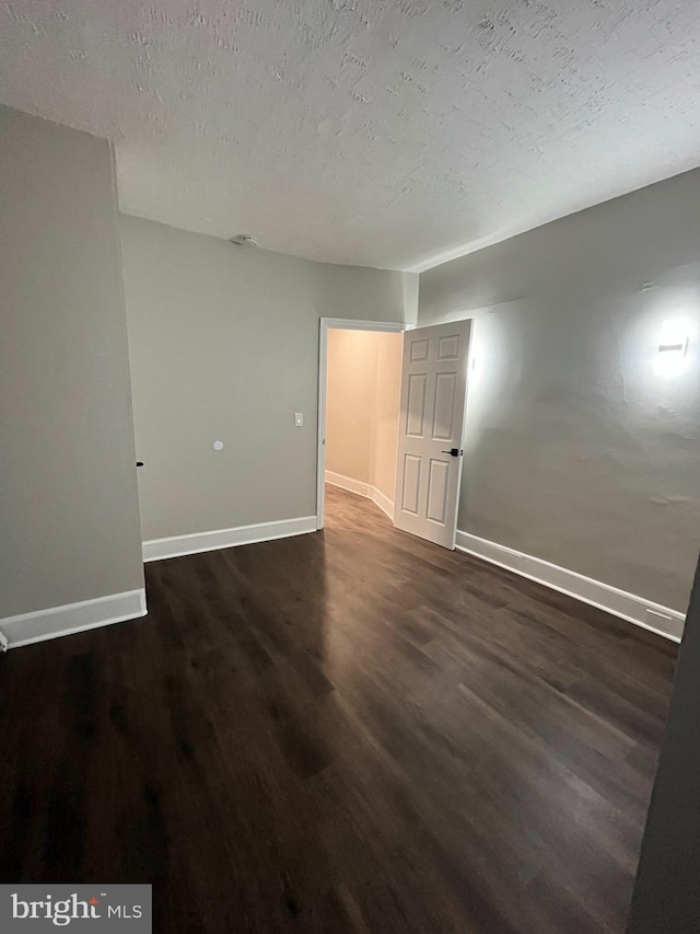 300 Darcy Ave, Hamilton, NJ 08629 - spare room featuring dark wood finished floors, baseboards, and a textured ceiling