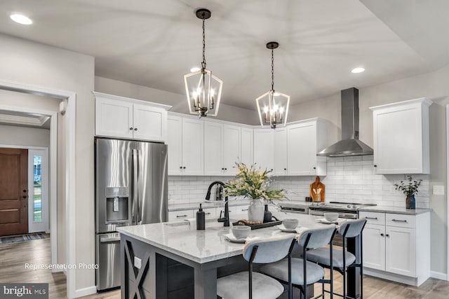 187 W Stewart Ct, Marysville, PA 17053 - kitchen with wall chimney range hood, stainless steel fridge, white cabinets, and recessed lighting