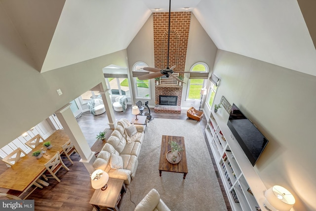 15220 Highview Ct, Waterford, VA 20197 - living room featuring high vaulted ceiling, wood finished floors, a ceiling fan, a fireplace, and baseboards