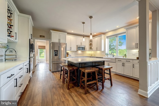 15220 Highview Ct, Waterford, VA 20197 - kitchen featuring stainless steel appliances, plenty of natural light, a breakfast bar, white cabinets, and recessed lighting