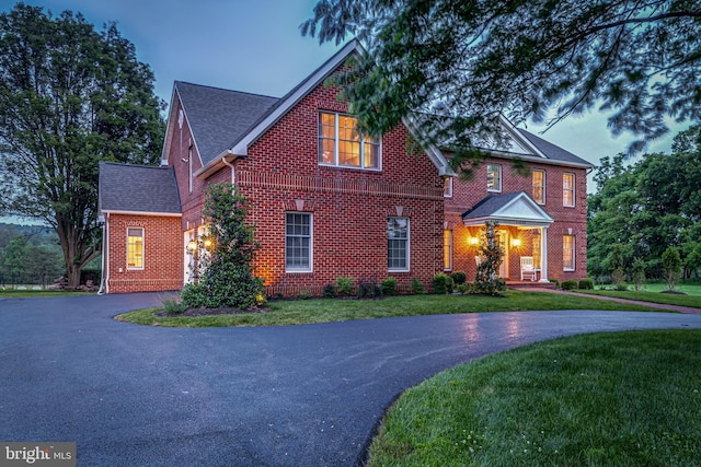 15220 Highview Ct, Waterford, VA 20197 - view of front of property with curved driveway, brick siding, a front yard, and roof with shingles
