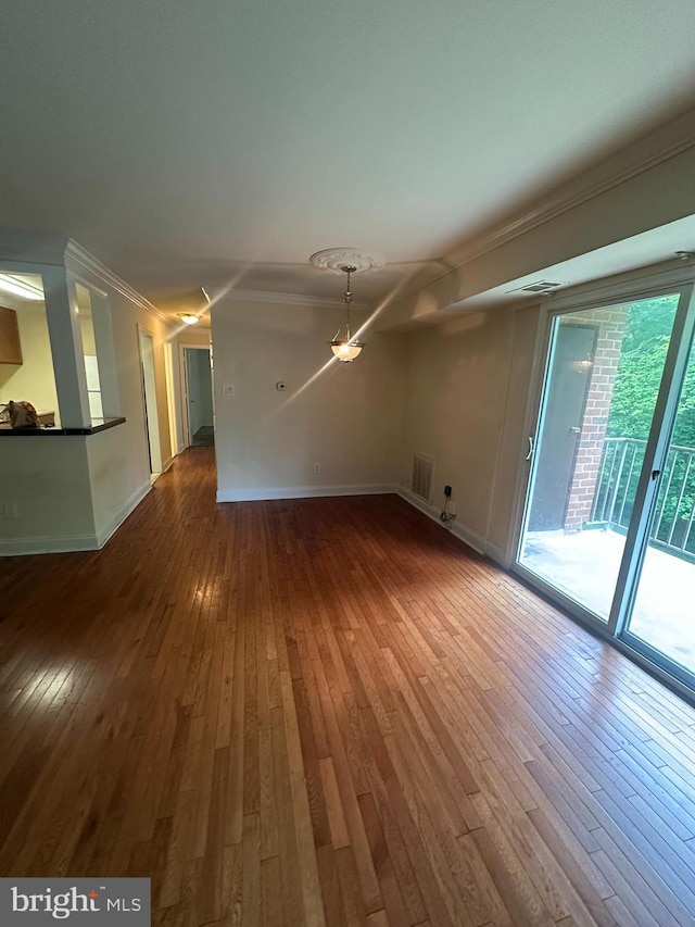 7971 Audubon Ave Unit 202, Alexandria, VA 22306 - unfurnished living room featuring wood-type flooring, baseboards, and crown molding