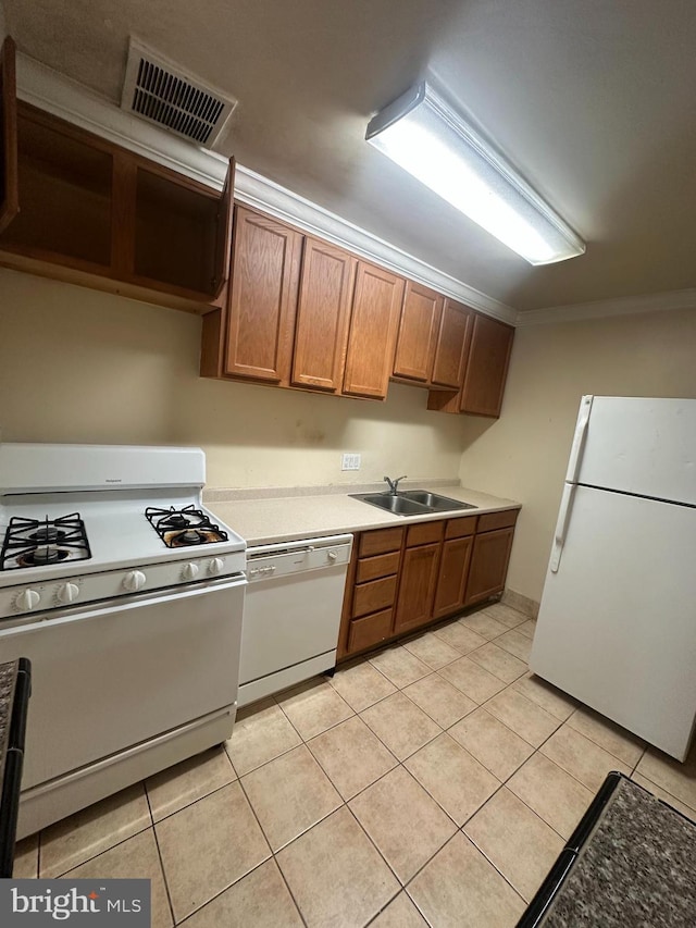 7971 Audubon Ave Unit 202, Alexandria, VA 22306 - kitchen featuring white appliances, a sink, light tile patterned floors, crown molding, and light countertops