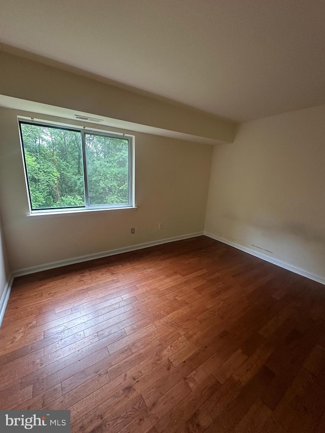 7971 Audubon Ave Unit 202, Alexandria, VA 22306 - empty room featuring hardwood / wood-style floors, healthy amount of natural light, and baseboards