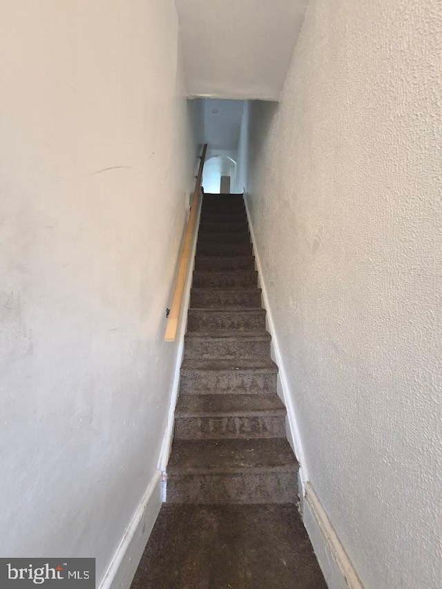 507 Newton Ave, Camden, NJ 08103 - stairs featuring a textured wall, wood finished floors, and baseboards