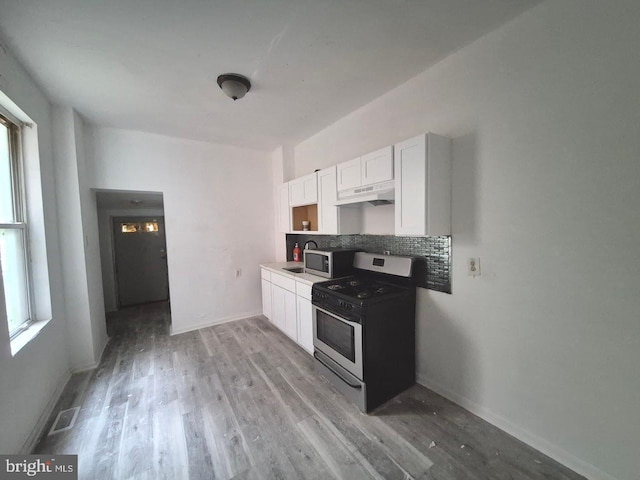 507 Newton Ave, Camden, NJ 08103 - kitchen featuring appliances with stainless steel finishes, under cabinet range hood, white cabinets, and healthy amount of natural light