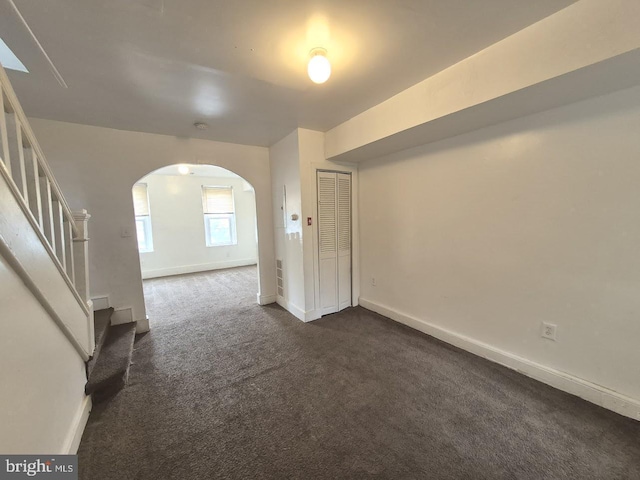 507 Newton Ave, Camden, NJ 08103 - unfurnished room with arched walkways, stairway, dark colored carpet, and baseboards