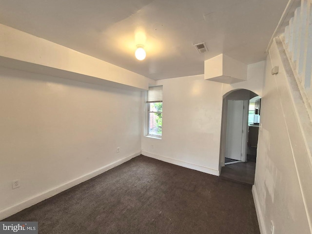 507 Newton Ave, Camden, NJ 08103 - unfurnished room with arched walkways, dark colored carpet, and baseboards
