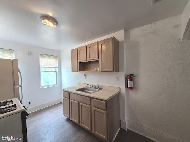 507 Newton Ave, Camden, NJ 08103 - kitchen with freestanding refrigerator, a sink, gas range, dark wood finished floors, and baseboards