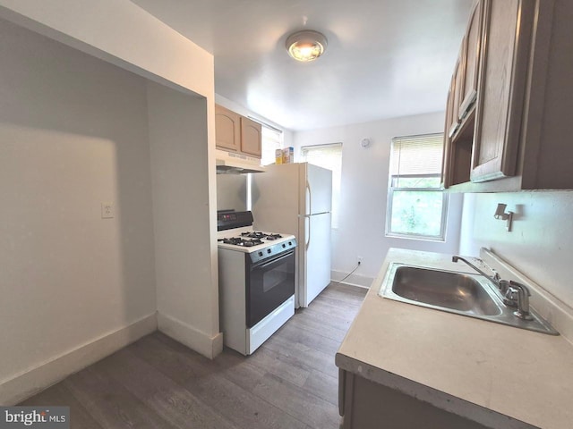 507 Newton Ave, Camden, NJ 08103 - kitchen with white appliances, under cabinet range hood, wood finished floors, a sink, and baseboards