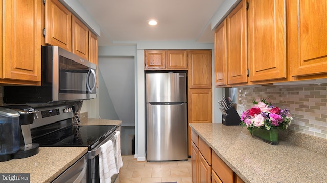 4421 36th St S, Arlington, VA 22206 - kitchen with stainless steel appliances, backsplash, brown cabinets, light tile patterned floors, and recessed lighting