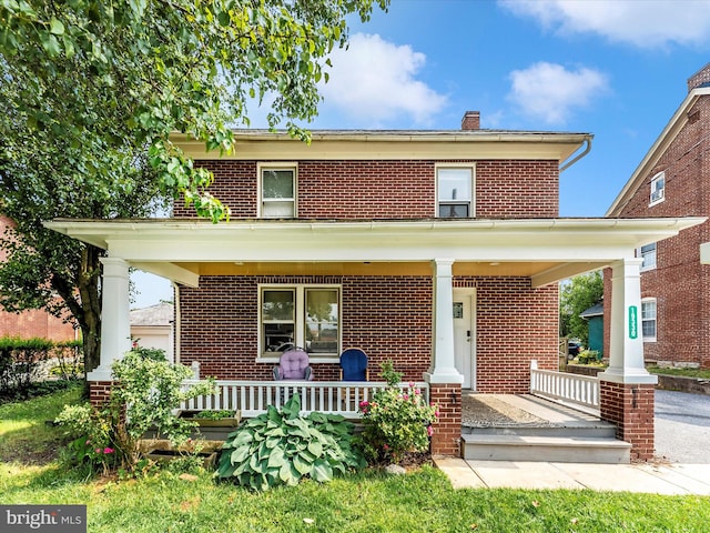 19330 Longmeadow Rd, Hagerstown, MD 21742 - american foursquare style home featuring a porch, brick siding, and a chimney