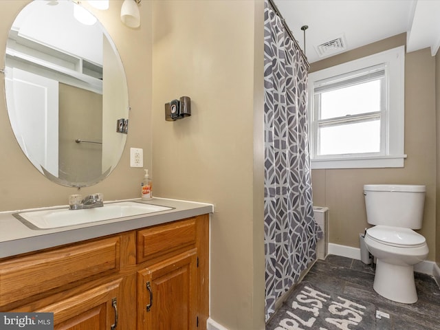 19330 Longmeadow Rd, Hagerstown, MD 21742 - full bathroom with vanity, toilet, baseboards, stone finish floors, and a shower with curtain