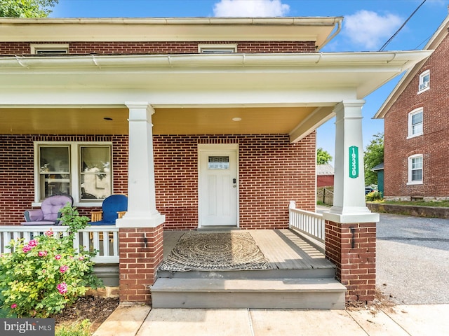 19330 Longmeadow Rd, Hagerstown, MD 21742 - doorway to property with covered porch and brick siding