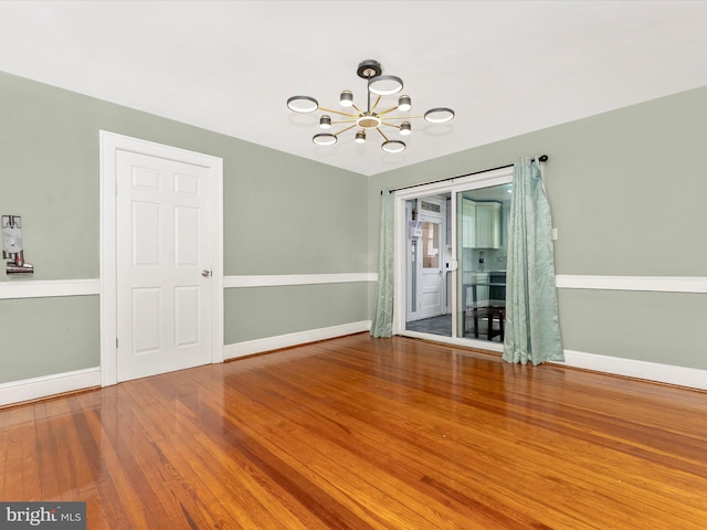 19330 Longmeadow Rd, Hagerstown, MD 21742 - unfurnished room with a chandelier, wood finished floors, and baseboards