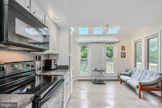 1 Second Tee Ct, Baltimore, MD 21209 - kitchen featuring black appliances, a skylight, white cabinetry, and open floor plan
