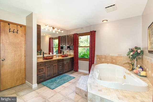 400 Berry Mountain Rd, Millersburg, PA 17061 - full bathroom with vanity, a jetted tub, and tile patterned floors