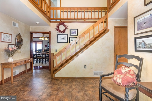 400 Berry Mountain Rd, Millersburg, PA 17061 - staircase featuring a chandelier, baseboards, and a towering ceiling