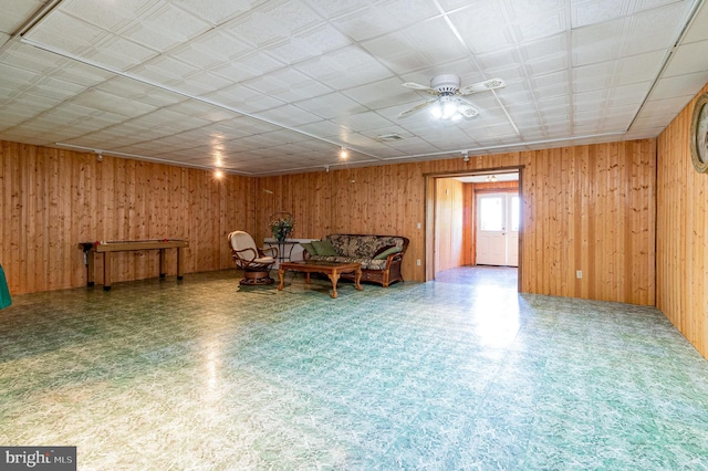 400 Berry Mountain Rd, Millersburg, PA 17061 - sitting room with tile patterned floors, wood walls, and a ceiling fan