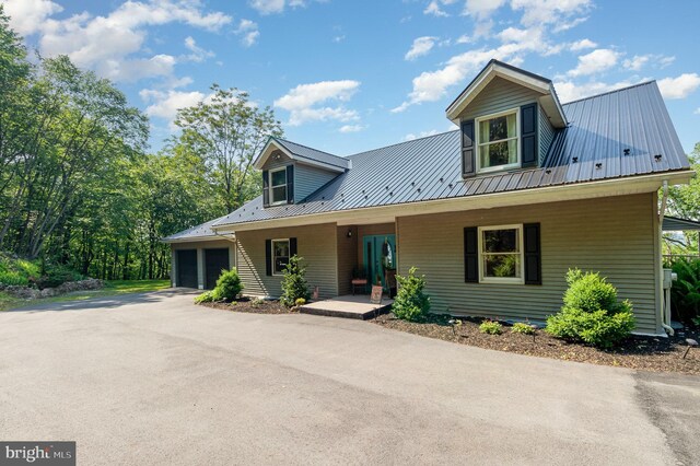 400 Berry Mountain Rd, Millersburg, PA 17061 - view of front of property featuring covered porch, metal roof, and a garage