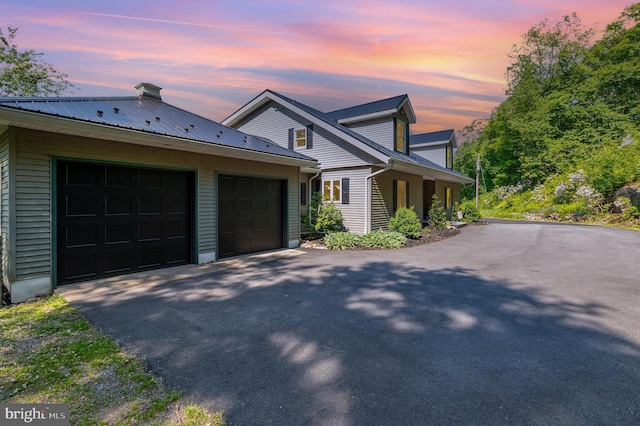 400 Berry Mountain Rd, Millersburg, PA 17061 - view of property exterior featuring asphalt driveway, a garage, and metal roof