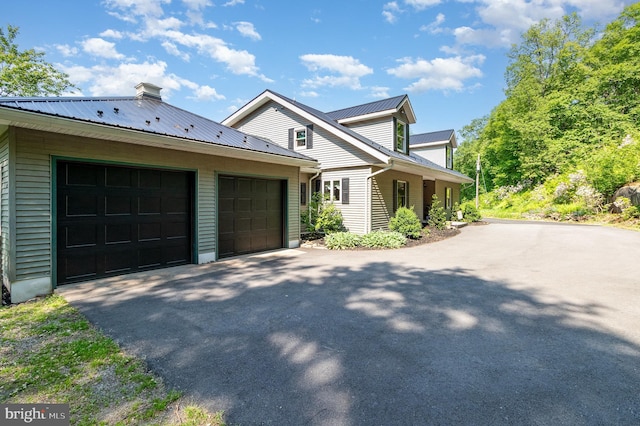 400 Berry Mountain Rd, Millersburg, PA 17061 - view of home's exterior featuring driveway, metal roof, and a garage