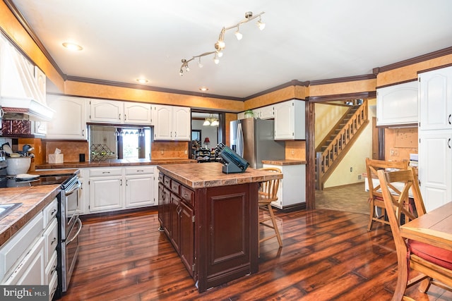 400 Berry Mountain Rd, Millersburg, PA 17061 - kitchen with stainless steel appliances, crown molding, white cabinets, tile countertops, and dark wood-style floors