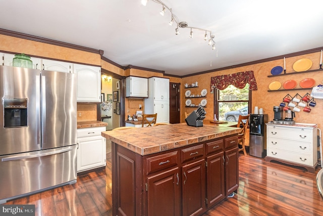 400 Berry Mountain Rd, Millersburg, PA 17061 - kitchen with stainless steel fridge, dark wood-type flooring, white cabinets, ornamental molding, and a center island