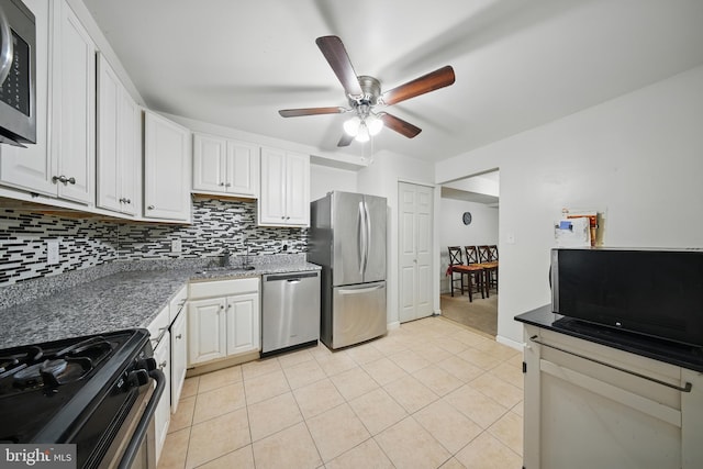 4408 Island Pl Unit T2, Annandale, VA 22003 - kitchen featuring stainless steel appliances, backsplash, ceiling fan, white cabinetry, and light tile patterned floors