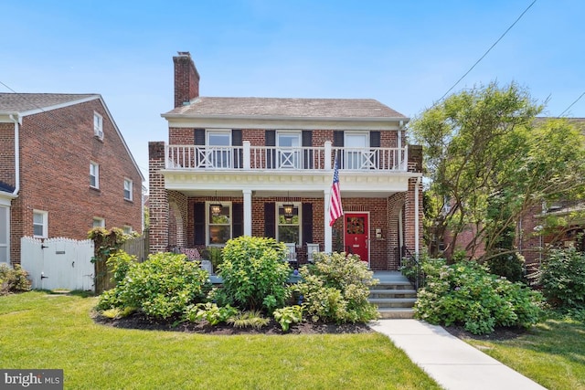 1346 Tuckerman St NW, Washington, DC 20011 - colonial-style house with brick siding, a balcony, covered porch, and a chimney