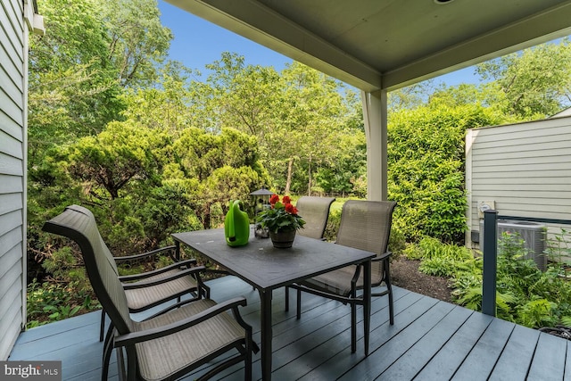 303 Knoll Way, Rocky Hill, NJ 08553 - wooden deck with outdoor dining space, cooling unit, and view of scattered trees