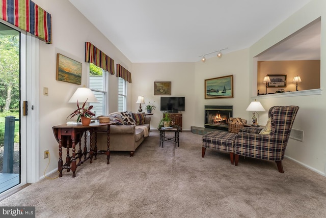 303 Knoll Way, Rocky Hill, NJ 08553 - carpeted living room with plenty of natural light, a glass covered fireplace, track lighting, and baseboards