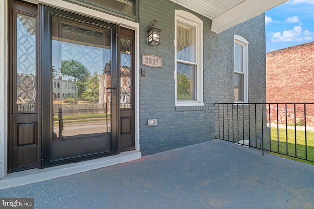 2817 Waldorf Ave, Baltimore, MD 21215 - doorway to property featuring a porch and brick siding
