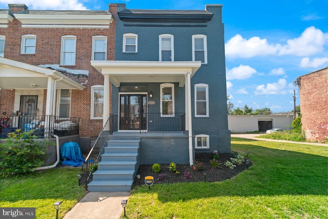 2817 Waldorf Ave, Baltimore, MD 21215 - multi unit property featuring brick siding, covered porch, and a front lawn