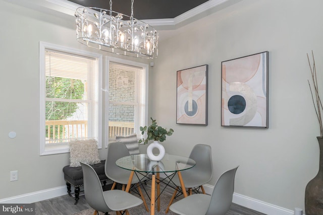 2817 Waldorf Ave, Baltimore, MD 21215 - dining room featuring a chandelier, baseboards, wood finished floors, healthy amount of natural light, and ornamental molding