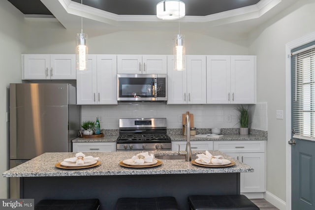 2817 Waldorf Ave, Baltimore, MD 21215 - kitchen with stainless steel appliances, a kitchen bar, white cabinetry, ornamental molding, and tasteful backsplash