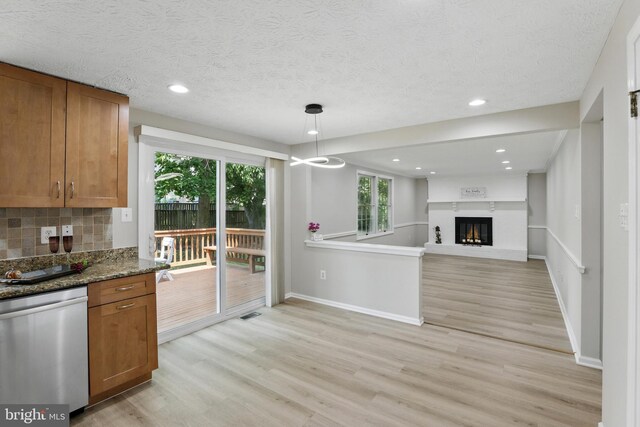 14612 Orangewood St, Silver Spring, MD 20905 - kitchen featuring stainless steel dishwasher, brown cabinets, light wood finished floors, baseboards, and recessed lighting