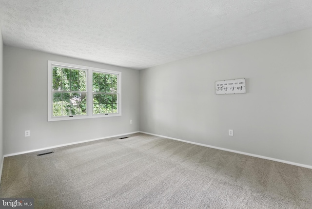 14612 Orangewood St, Silver Spring, MD 20905 - carpeted spare room featuring a textured ceiling and baseboards